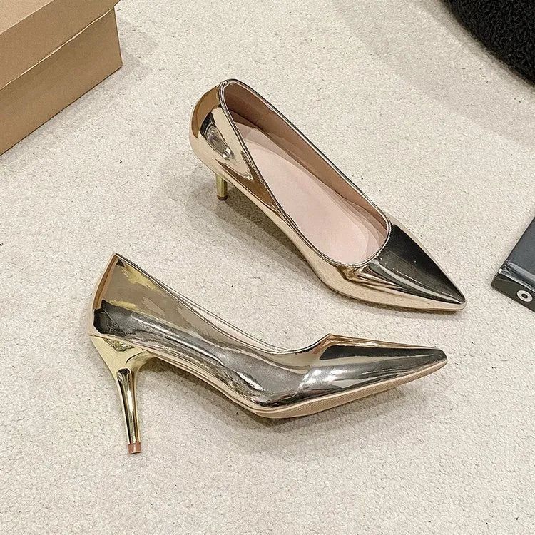 Gold and silver pointed toe slip-on pumps with stiletto heel on white background