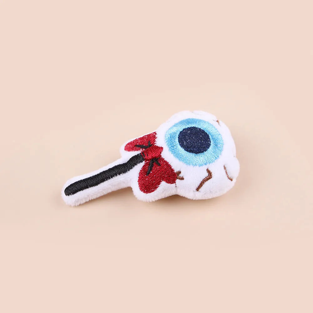 Small plush candy cat teaser wand on a stick in one of three colour designs: Eyes, Candy, or Skull.