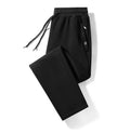 Plum Label men's large size casual sweatpants in flat black cotton knit with drawstring waist and skinny leg