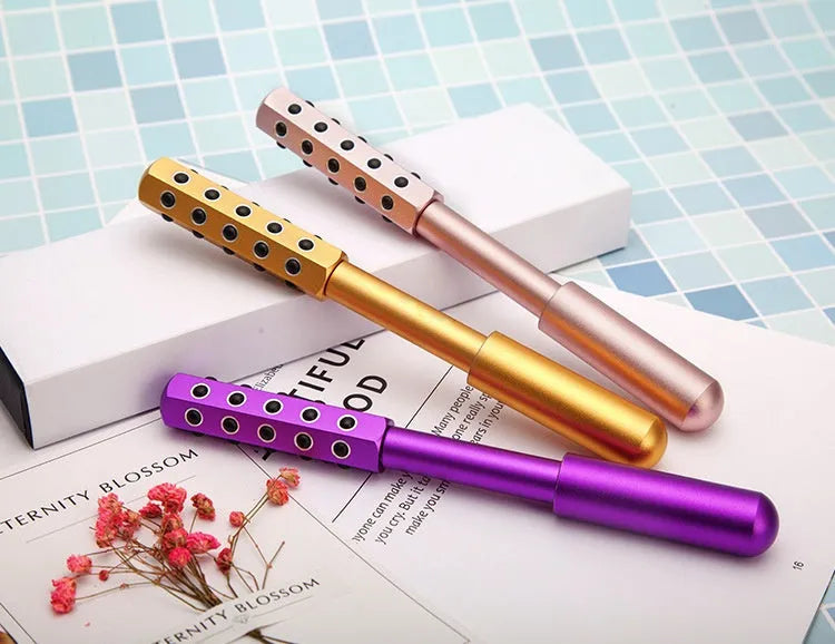 Purple handheld facial massage roller with 24 germanium beads, 193mm long
