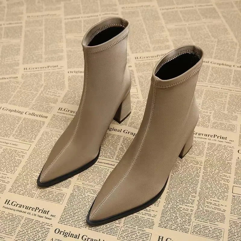 Women's khaki pointed-toe ankle boots with a wedge heel on a rubber sole.
