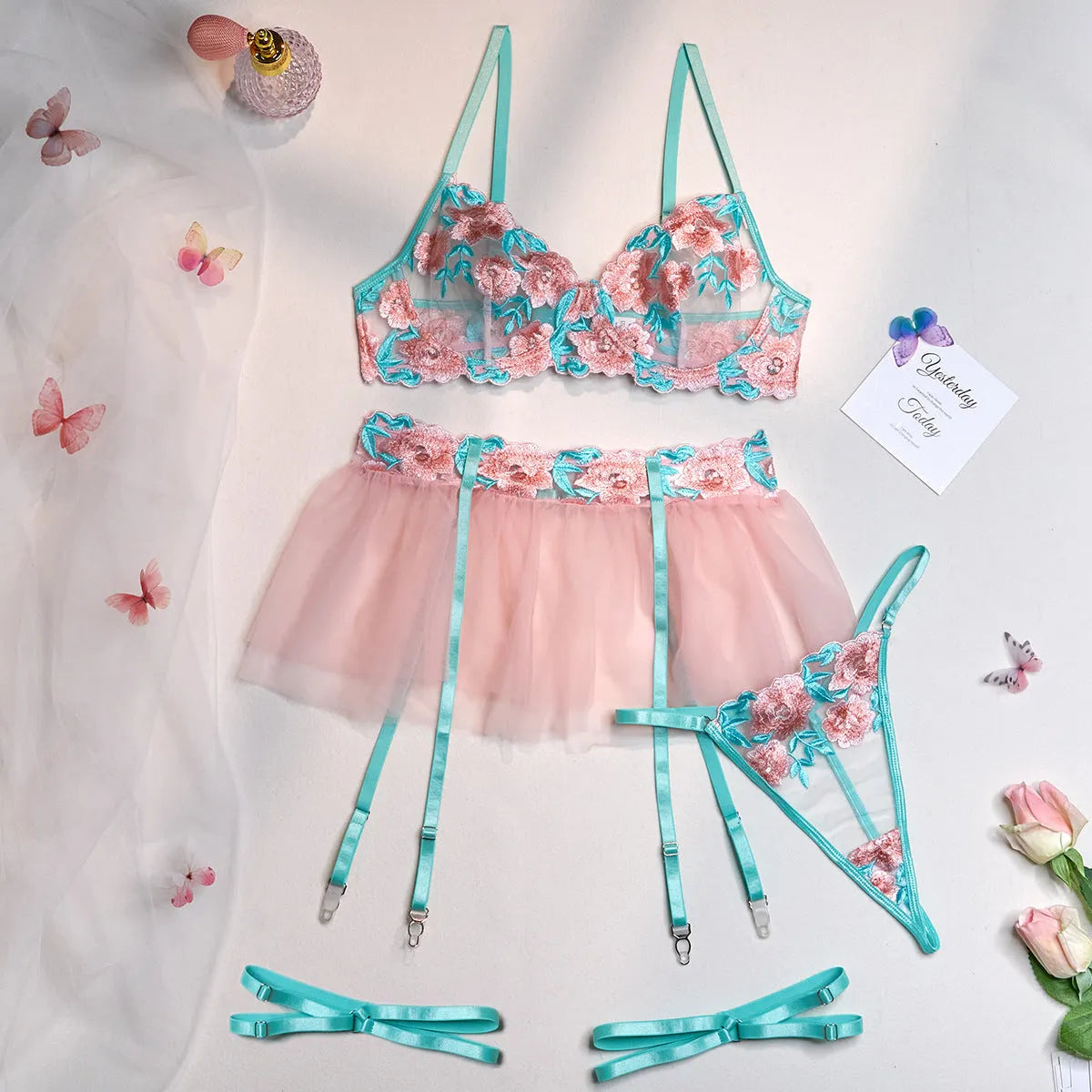 Pink women's bikini set with embroidery detail and a matching sheer mesh pettiskirt skirt.