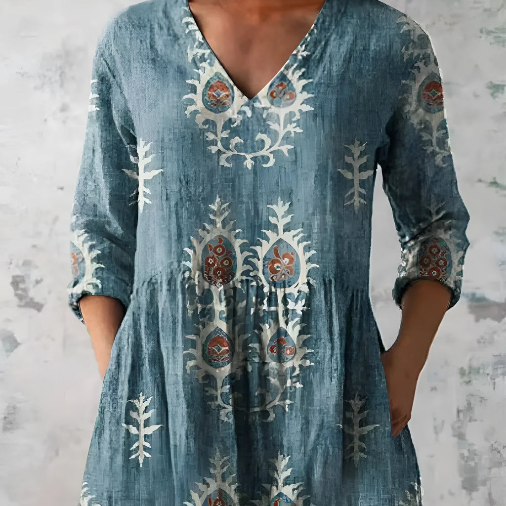 Women's printed loose-fit maxi dress with wide waist and three-quarter length sleeves.