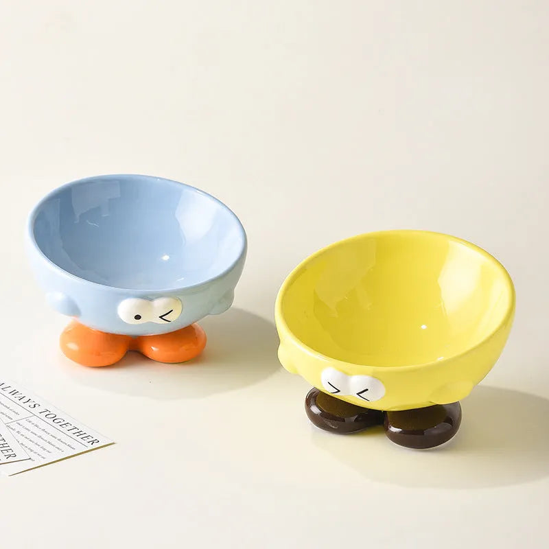 Blue tall ceramic pet food bowl with oblique shape and a silicone non-slip ring on the base.