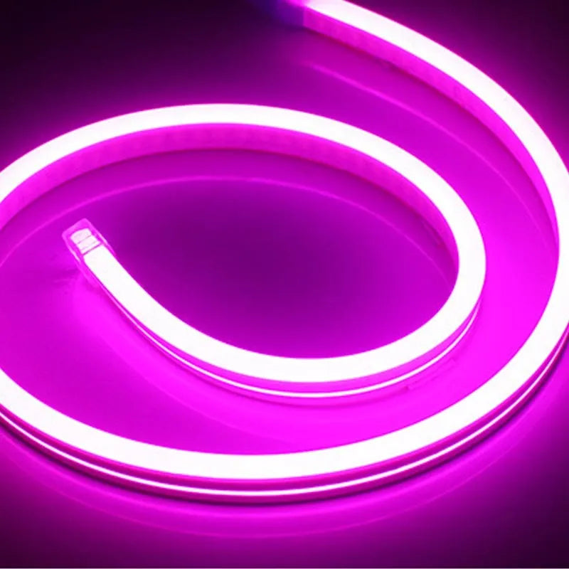 A 100-metre reel of flexible blue LED neon strip light showing its bendable silicone construction and bright illumination.