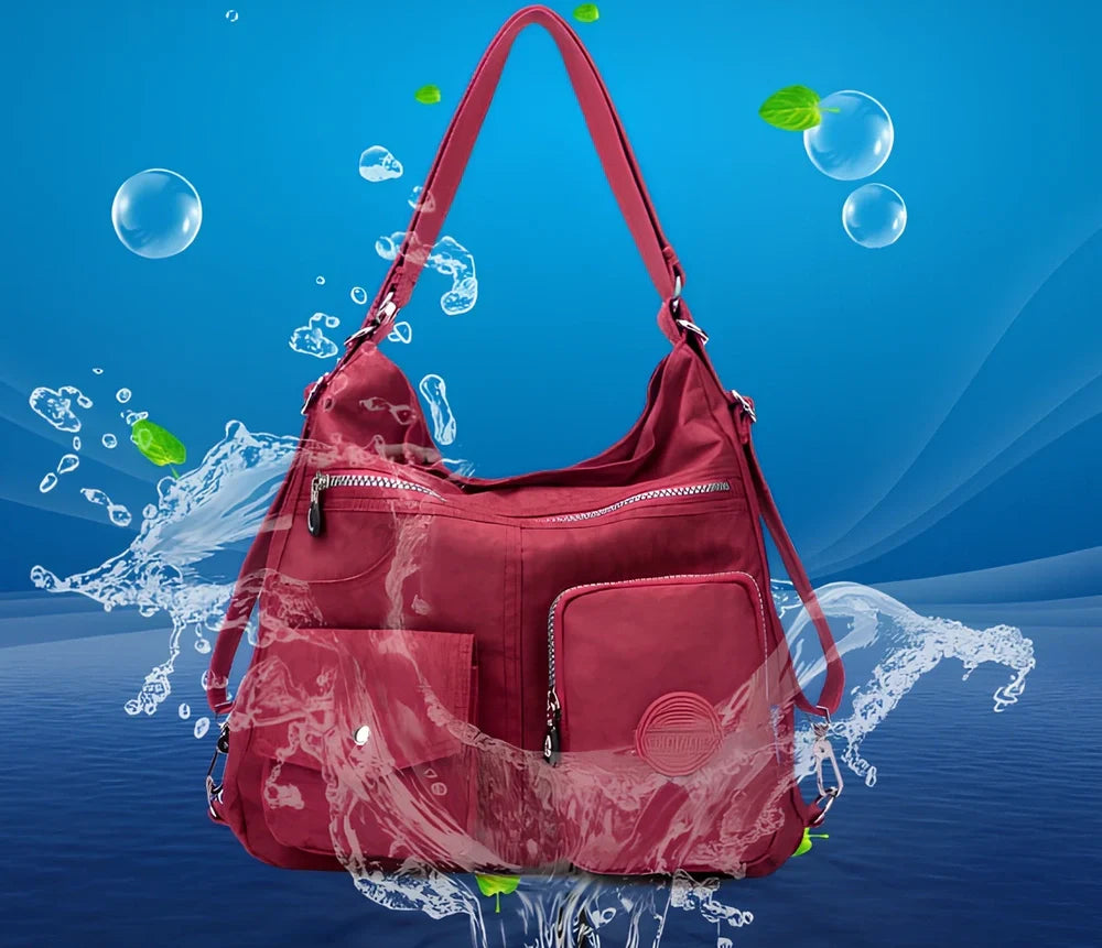 Women's waterproof nylon crossbody bag with organizational pockets and 34cm laptop capacity