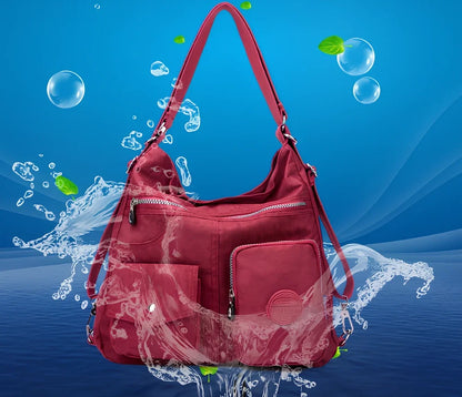 Women's waterproof nylon crossbody bag with organizational pockets and 34cm laptop capacity