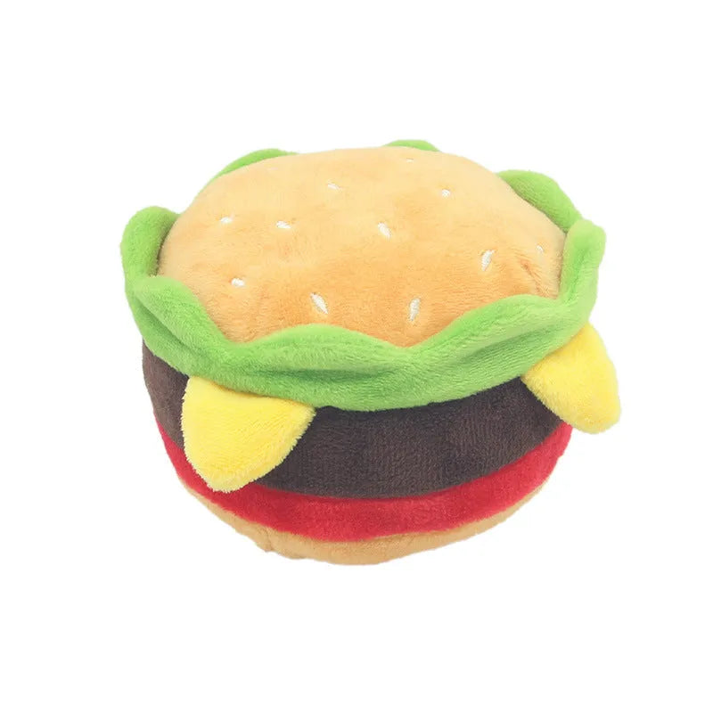 A selection of soft plush pet toys in hamburger, french fries, and milkshake cup designs.