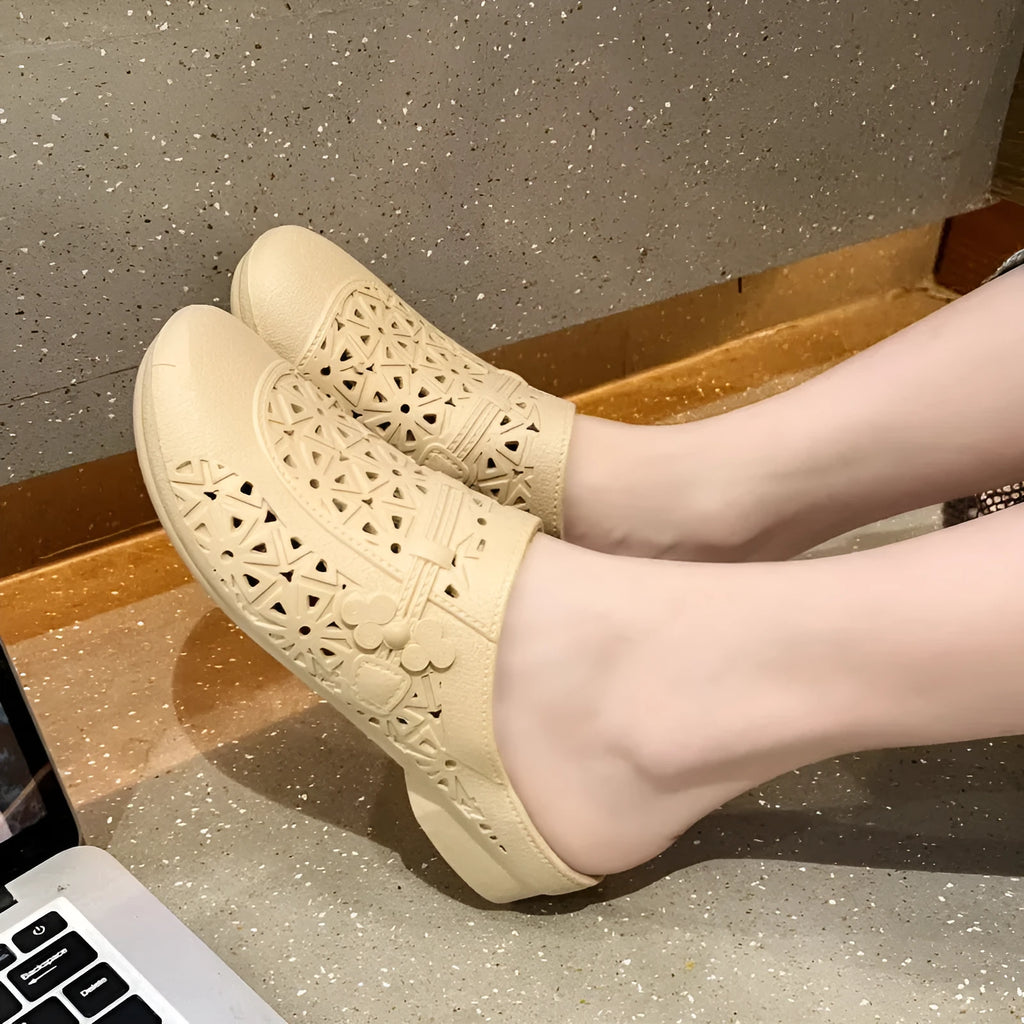 Apricot fairy style flat toe slippers with hollow-out pattern on a white background.
