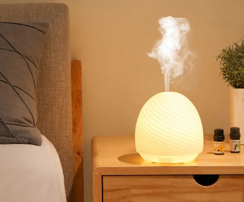 Asakusa threaded glass aroma diffuser in frosted white on a table with a single fog outlet