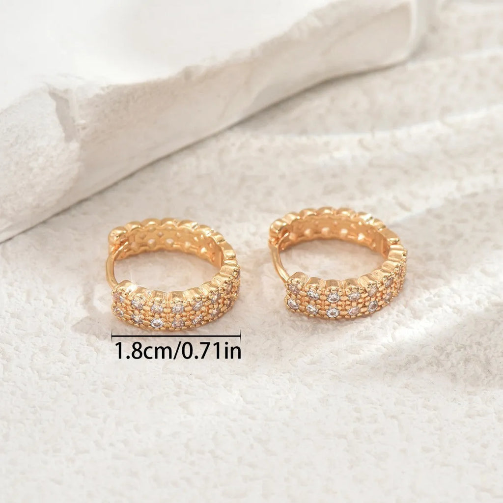 Copper geometry pattern ear studs with round, dot, and ring elements.