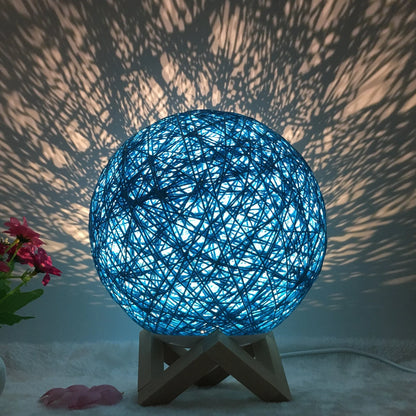 LED rattan table lamp with hand-knit lampshade in various colours