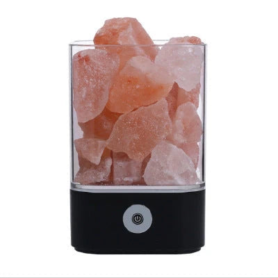 Himalayan salt lamp with natural pink-orange glow, releasing negative ions to purify the air and create a calming, relaxing atmosphere