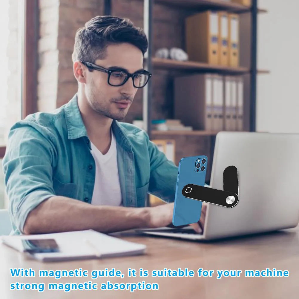Black aluminium laptop phone holder mounted beside laptop screen showing dual-screen setup