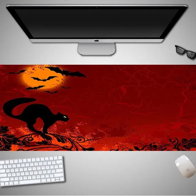 Oversized Halloween themed gaming mouse pad with non-slip rubber cloth base on a desk
