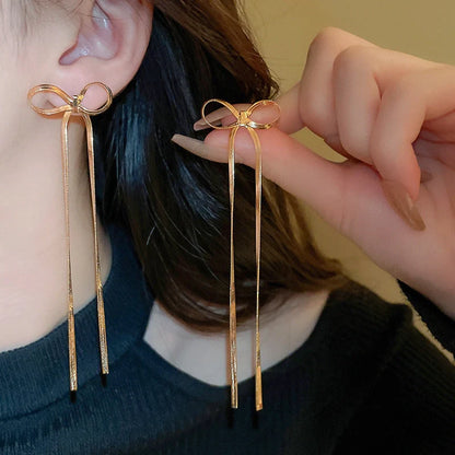 Hypoallergenic 18k gold plated herringbone bow earrings with tassel tails