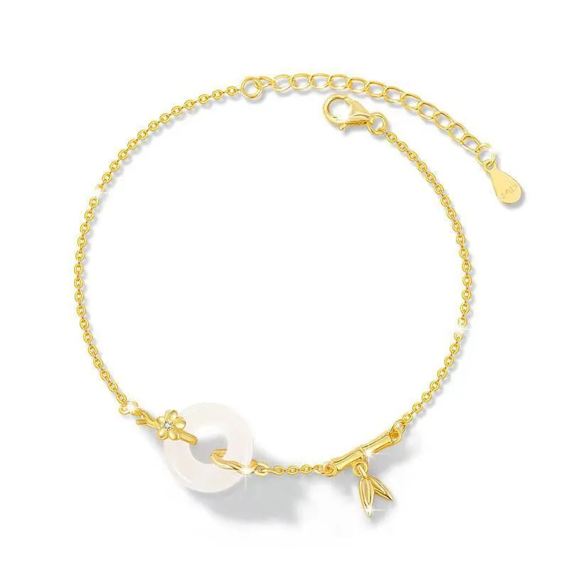 Gold-coloured women's silver bracelet with a peace buckle design and white chalcedony stone centrepiece.
