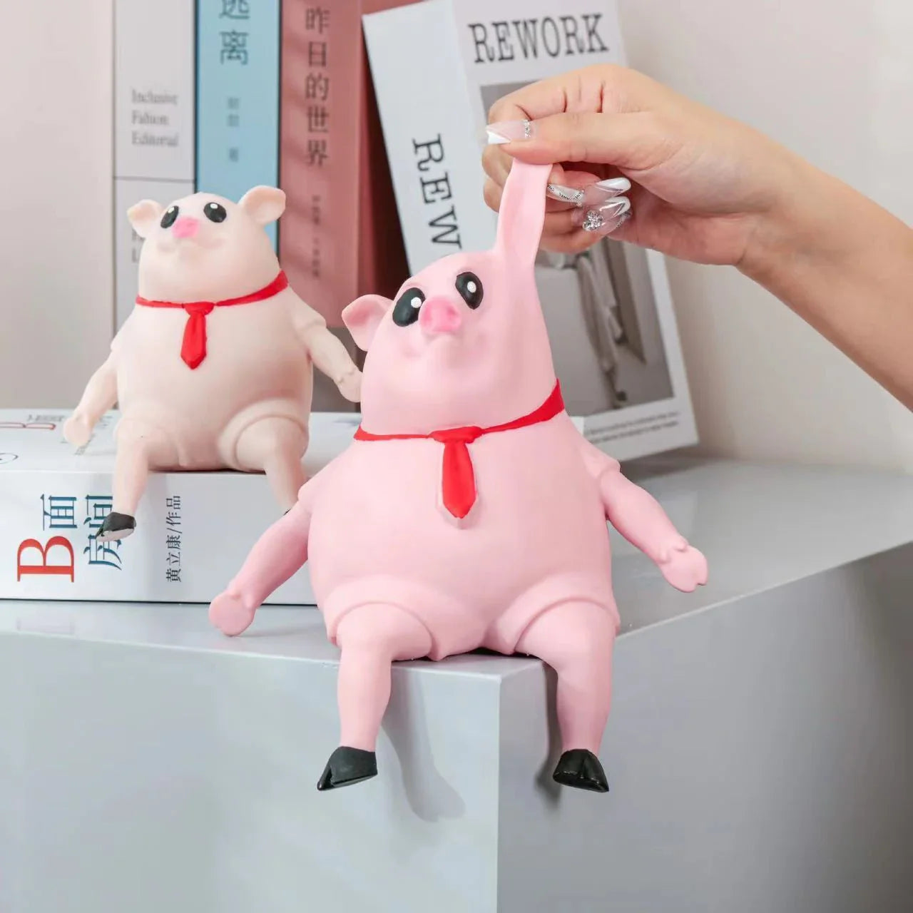 Piggy-shaped stress relief toys made from soft, eco-friendly rubber with cute scarf accents