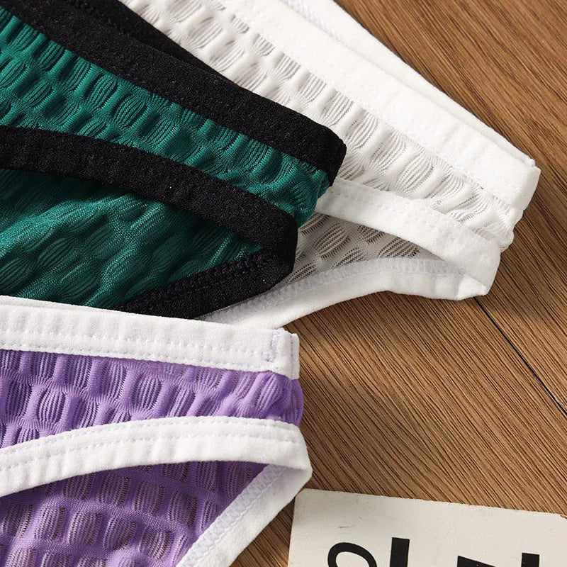 Men's low waist transparent nylon lace underwear in a solid colour with text print.