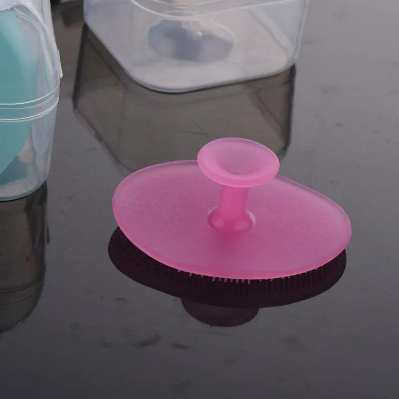 Silicone facial brush in three bristle zones with suction cup on blue background