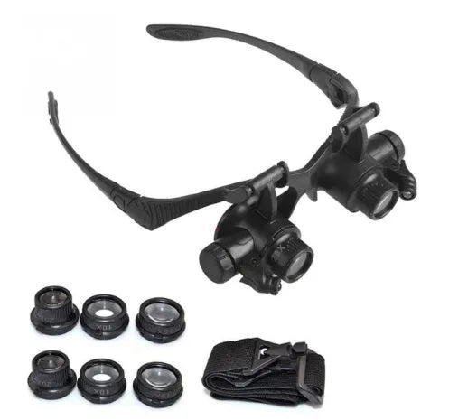Double eye LED magnifier glasses with headband and 4 interchangeable lenses on black background