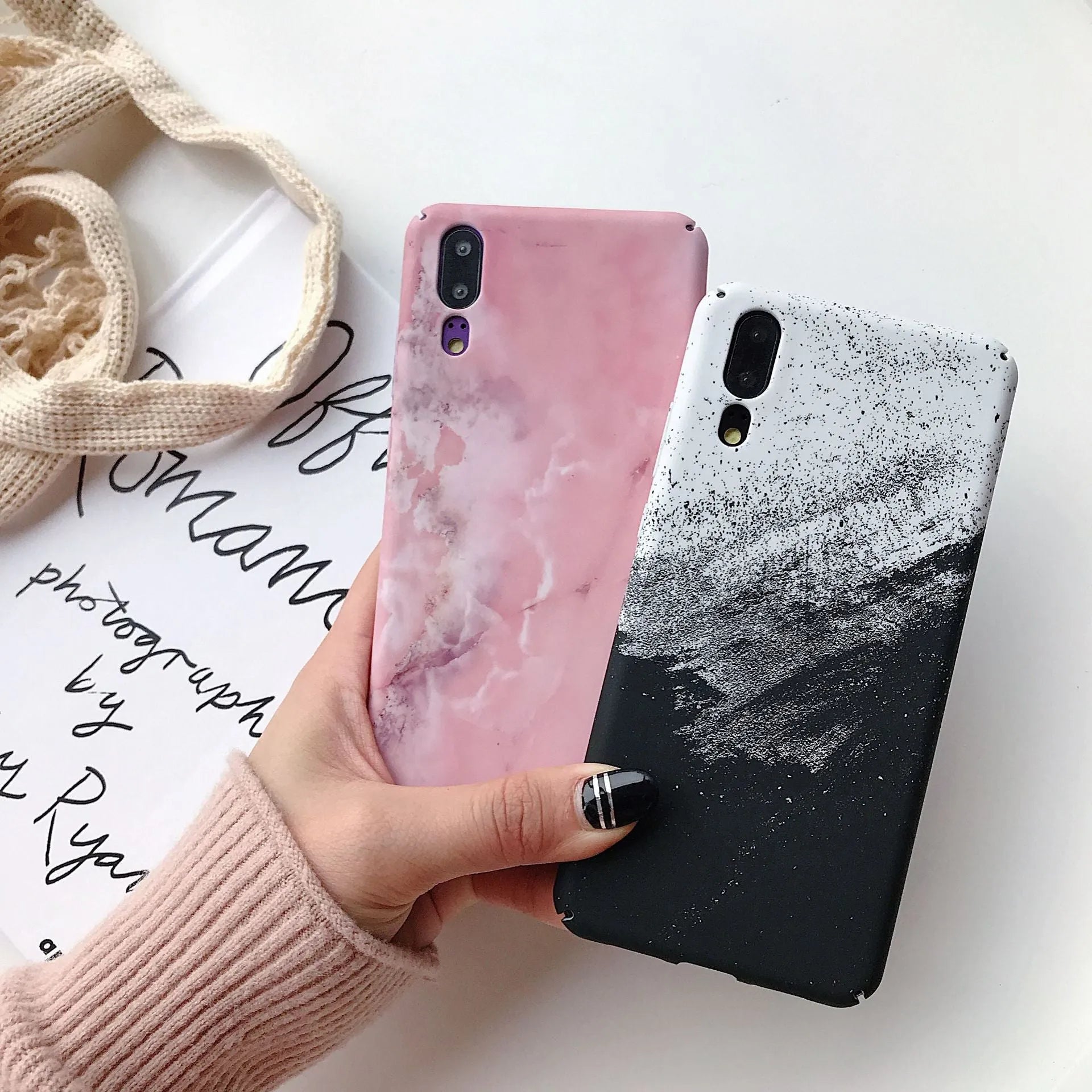Solid black and solid pink painted phone back covers for Huawei and Honor smartphones on a white background.