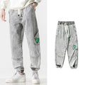 Men's loose-fit tapered cotton trousers in black, blue, or grey colours with mid waist design