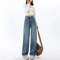 Woman wearing retro blue high waist wide leg jeans with a straight cut