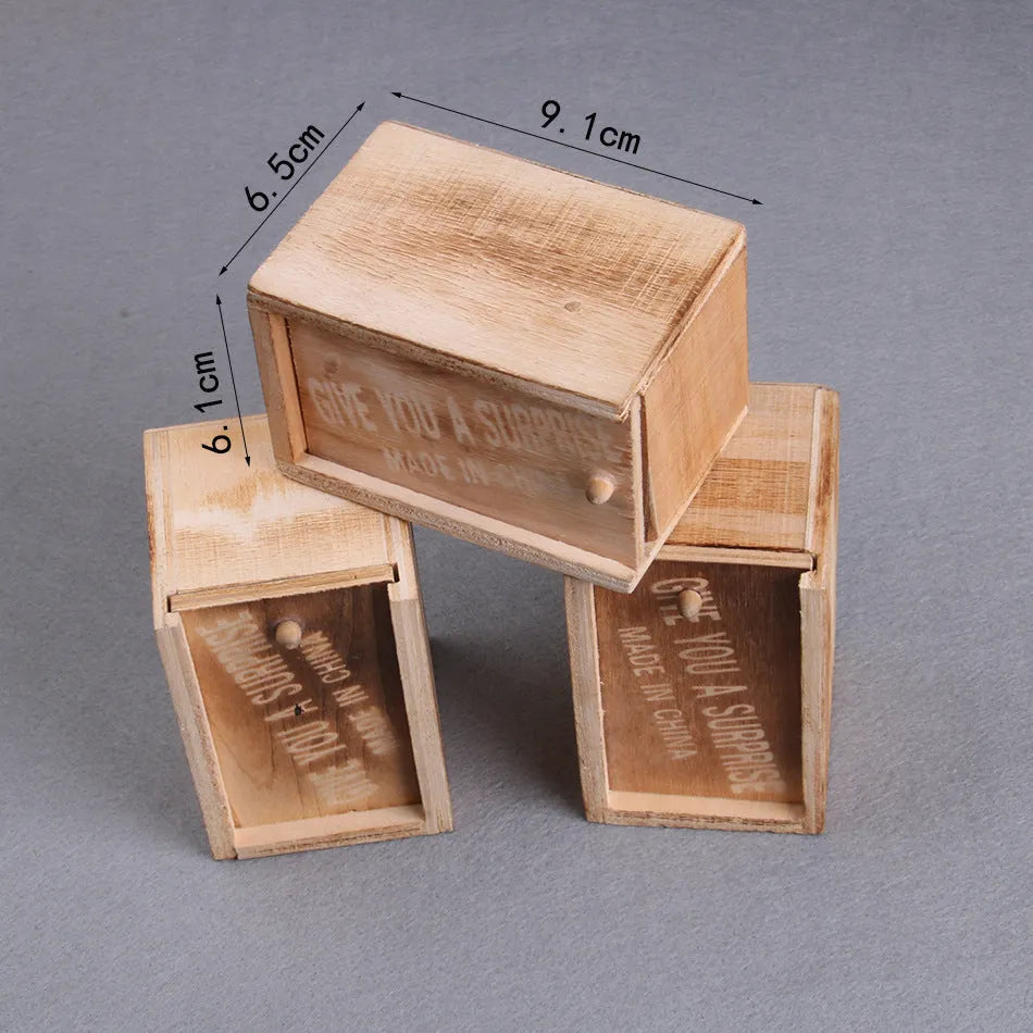 Wooden prank scare box closed on table, with random jumping animal surprise inside for April Fools' tricks.