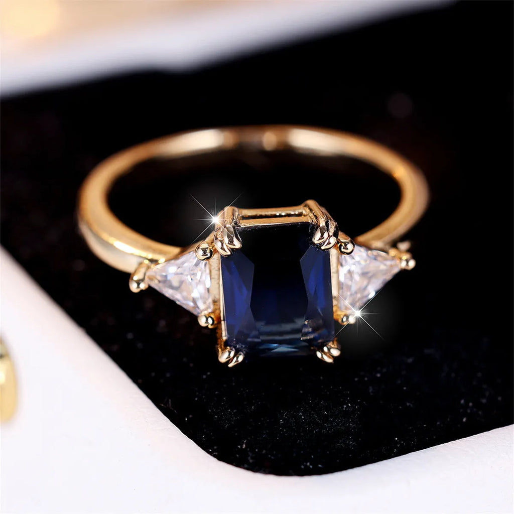 Rectangular copper ring with gold sapphire blue finish, shown on hand