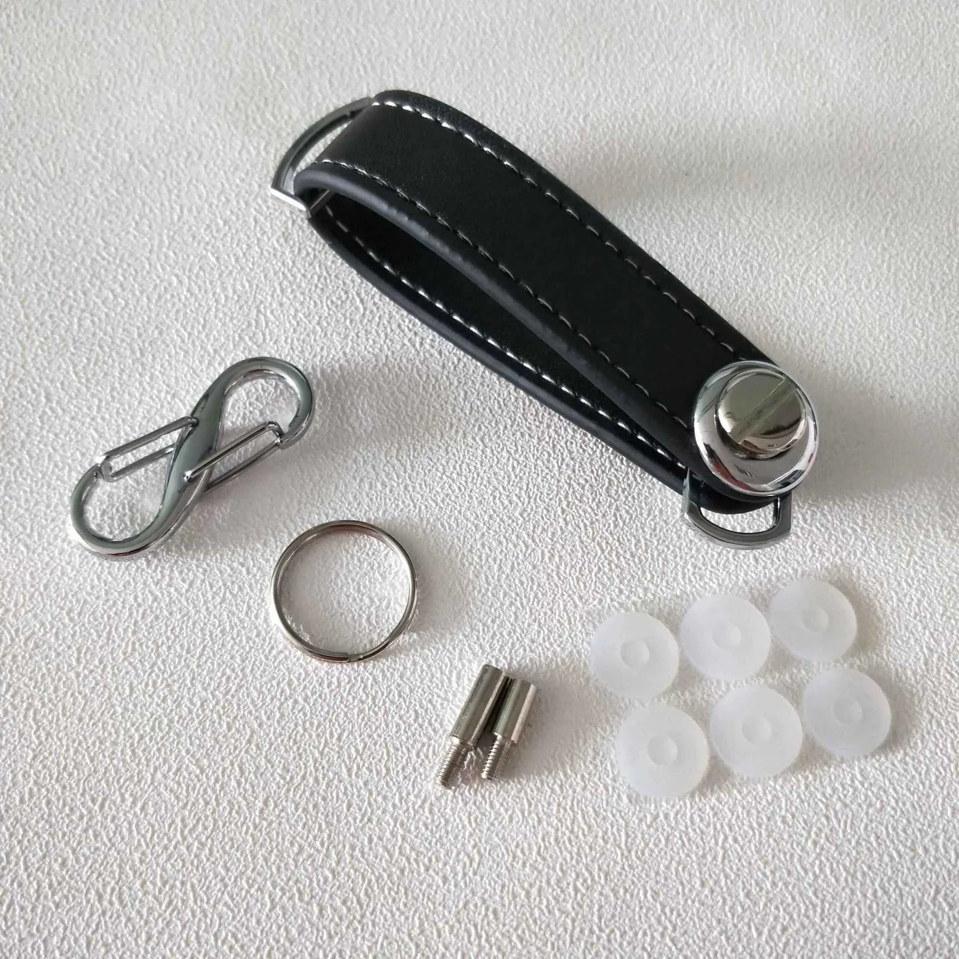 Creative folding key holder in metal copper chrome and cowhide, showing two keyposts and non-slip silicone pad, 85mm length