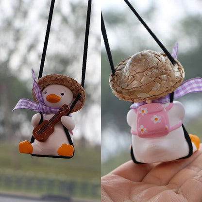 Swing Duck Car Pendant hanging from a rearview mirror, showcasing vibrant colors and unique design