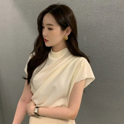 Women's apricot shirt with stand-up collar, diagonal pleats, and flowing short sleeves on hanger