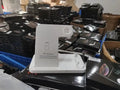 Black folding 4-in-1 wireless charger showing vertical stand for iPhone and flat charging pad.