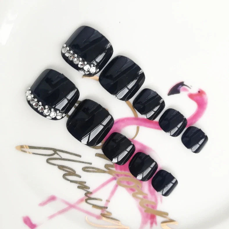 Black rhinestone toe nail patches with geometric and floral designs on adhesive backing