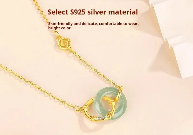 Handmade sterling silver bamboo joint peace buckle necklace with pearl details on an O-chain.