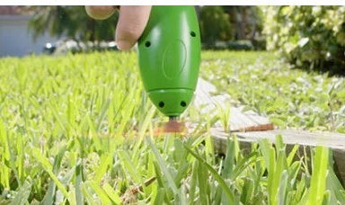 Cordless lawn trimmer with extension pole and protective debris shield for easy garden maintenance