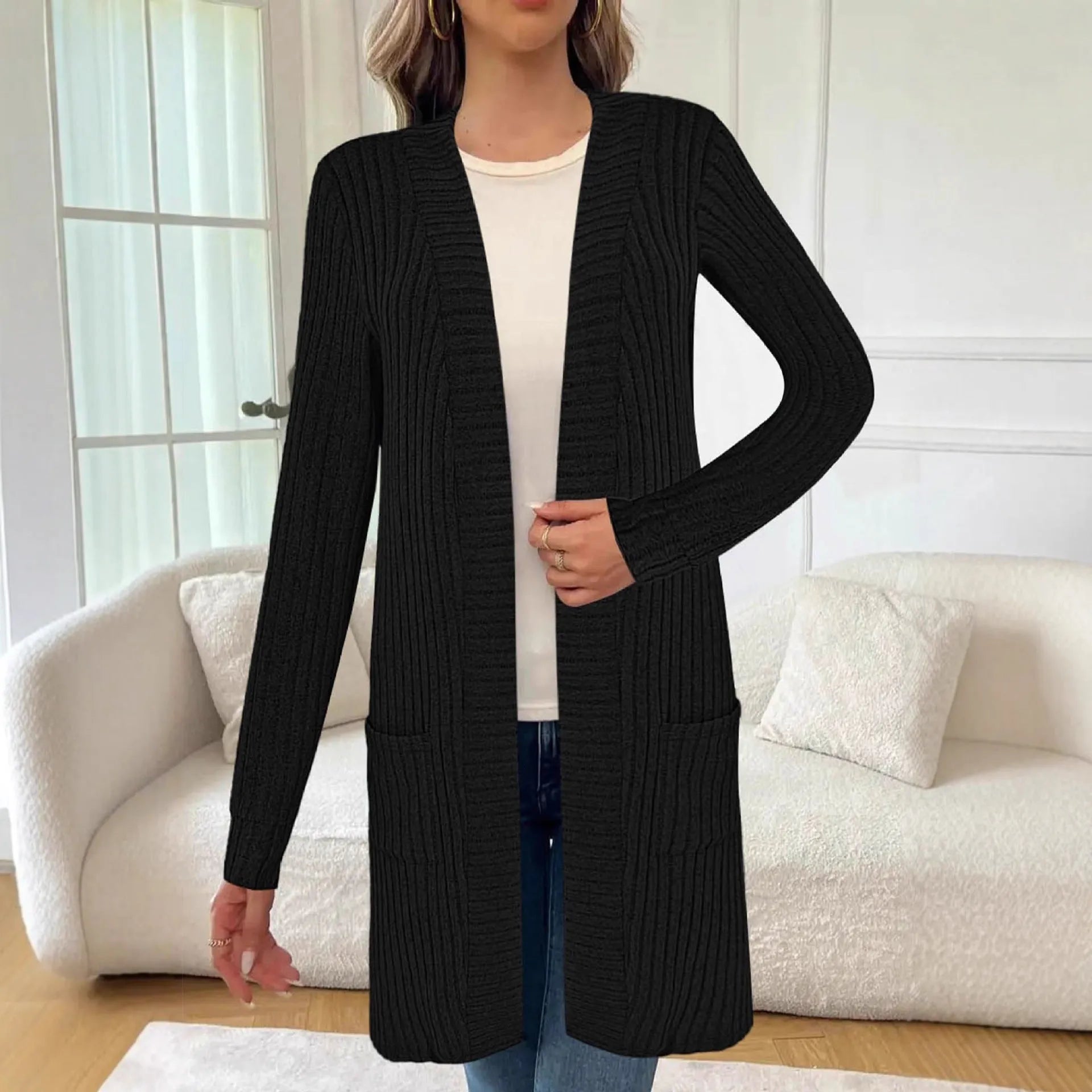 Black loose fit knitted cardigan jacket with long sleeves and side pockets on a mannequin.
