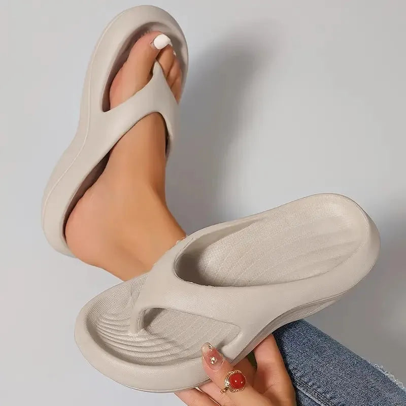 Women's black thick-soled EVA flip-flops with a non-slip patterned sole.