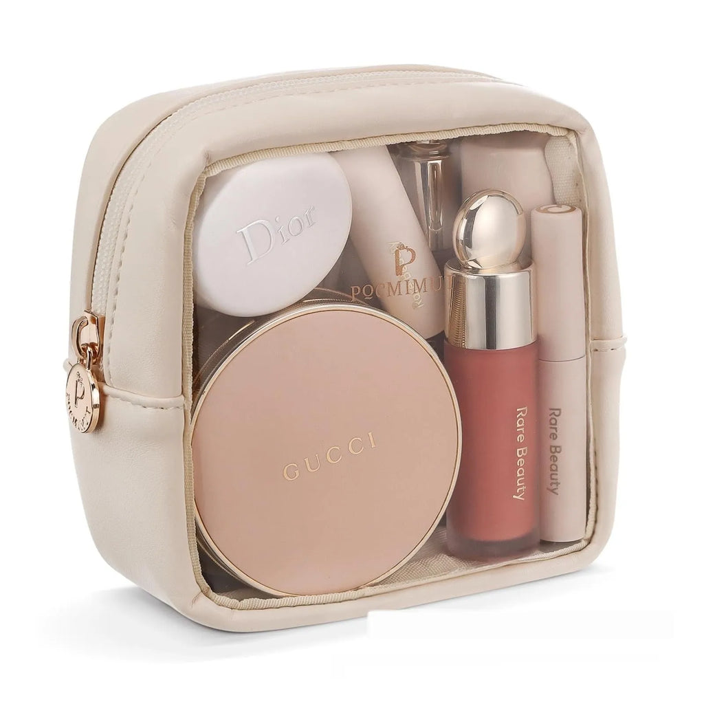 Clear PVC cosmetic bag with a zip open, showing a polyester lining and separate compartments.