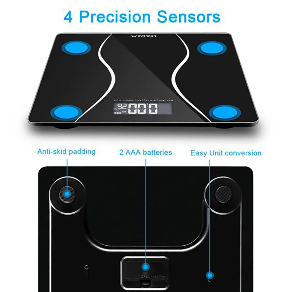 Black electronic body scale on a floor, showing digital display.