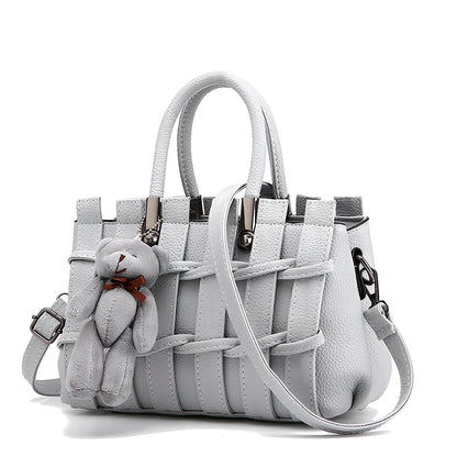 Women's black PU leather shoulder handbag showing four internal organisational compartments and adjustable strap