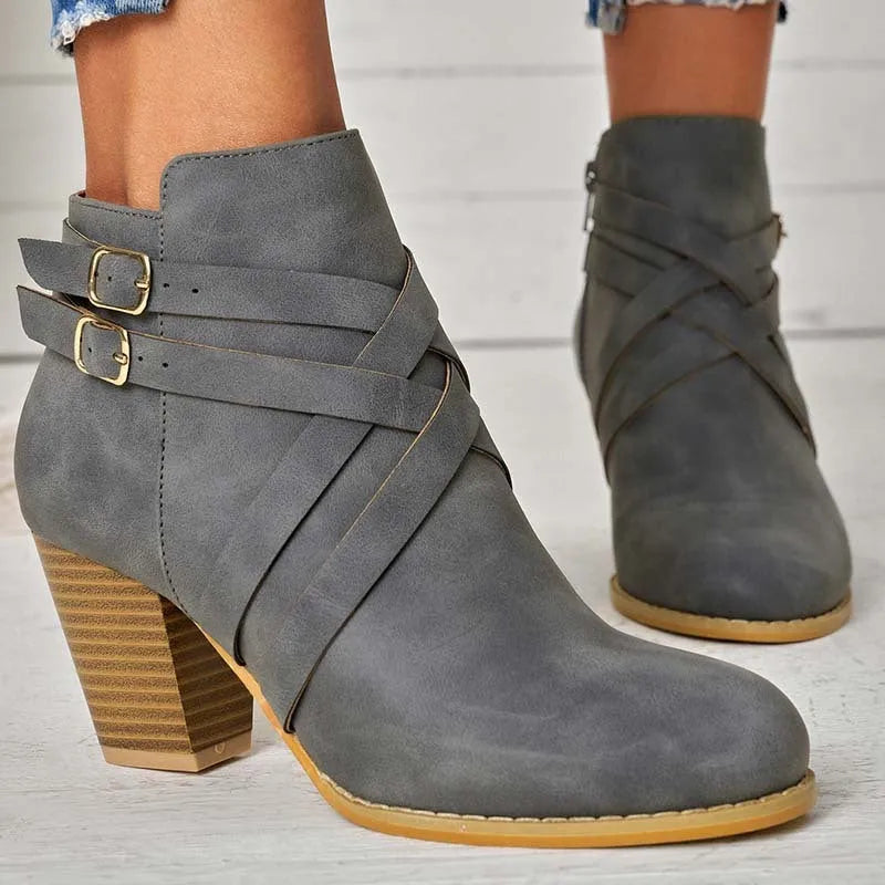 Women's grey ankle boot with 7cm block heel, side zipper, and buckle detail on a plain toe.