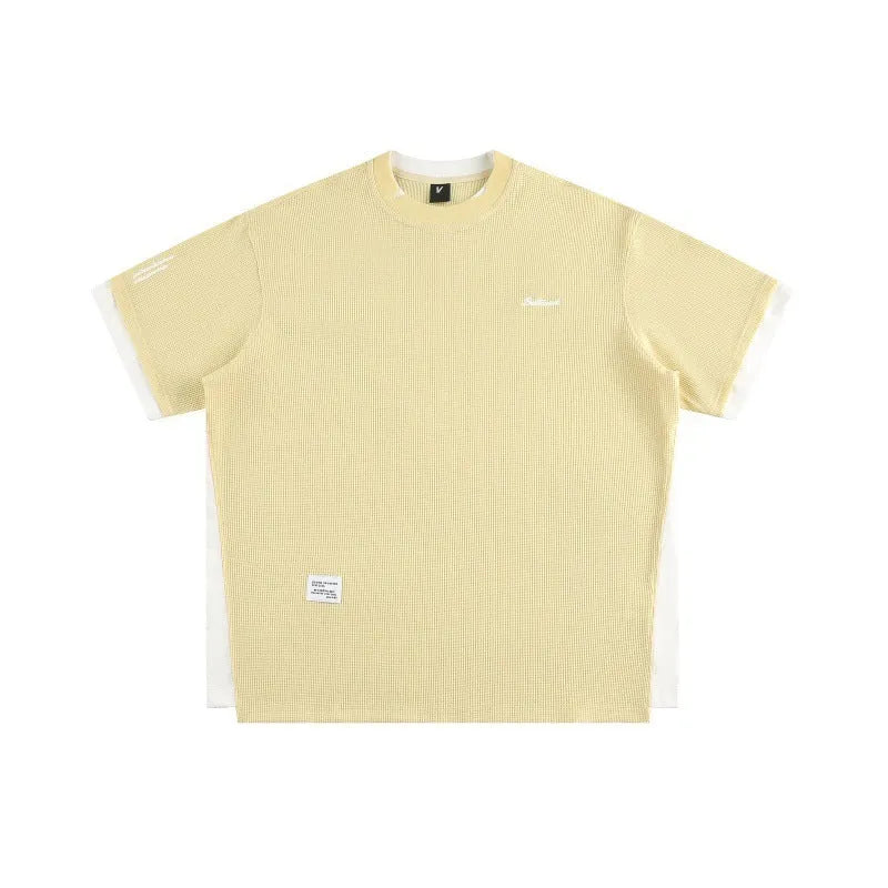 Loose waffle-knit short-sleeved t-shirt with retro alphabet embroidery on the front, shown in navy blue.