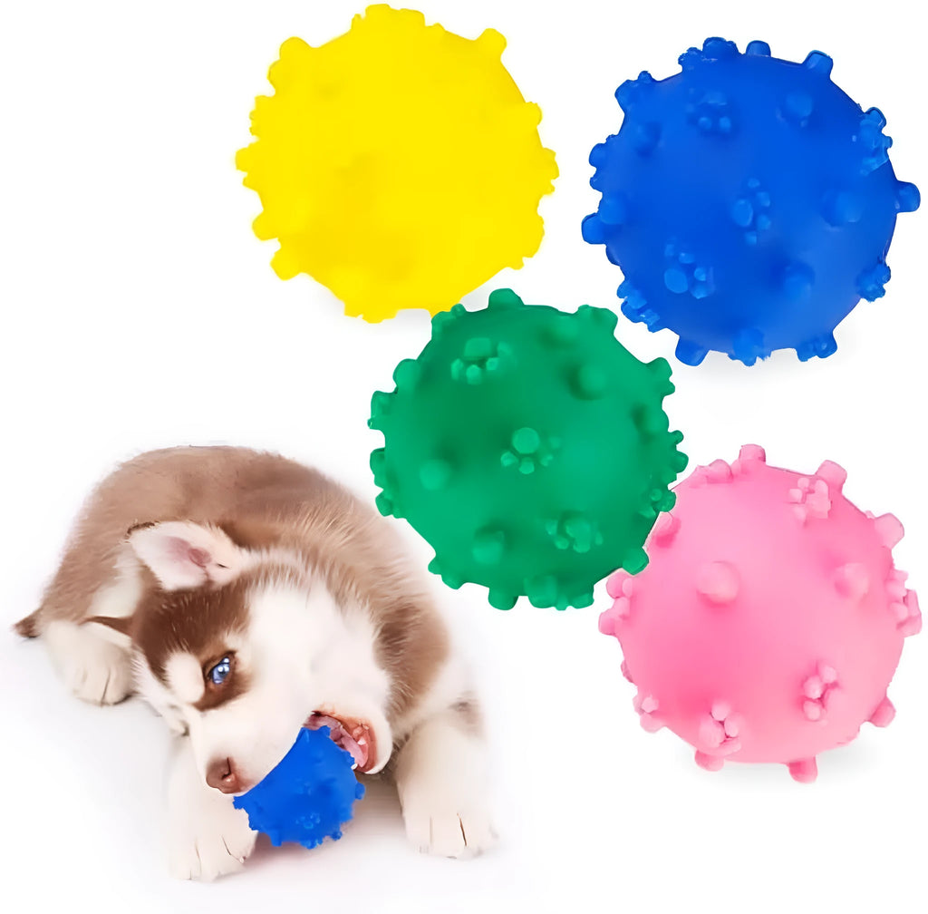 Set of bright blue, green, pink, and yellow spiked squeaky dog balls for small dogs on a lawn.