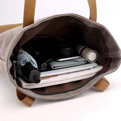 Canvas tote bag in black converts to backpack, 30x10x39cm size with zipper and polyester lining