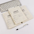 White A5 loose-leaf notebook inner pages with monthly plan layout on paper
