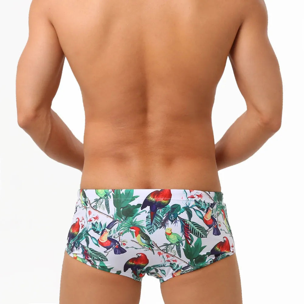 Men's floral bird print swim trunks with cup compartment in blue and white design