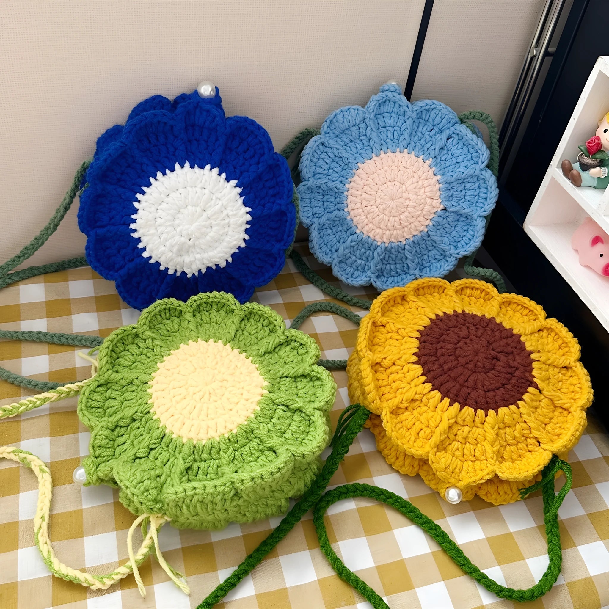 Round hand-woven wool bag with crocheted flowers, cotton lining, and mobile phone pocket