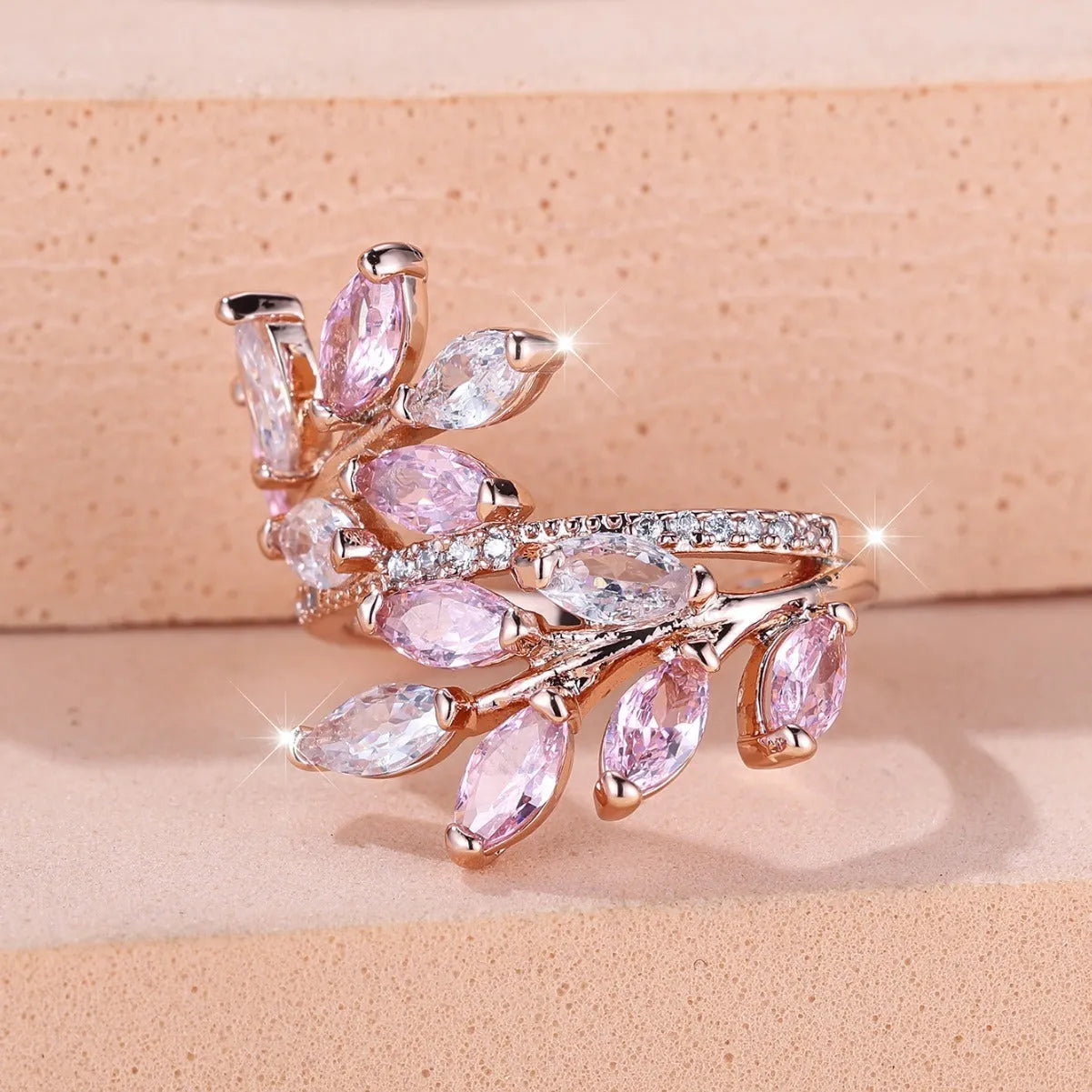 Adjustable copper leaf ring with a zircon stone in a choice of rose gold or platinum finishes.